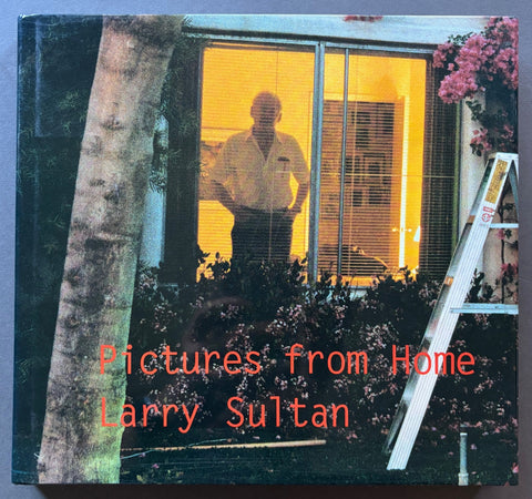 Book titled 'Pictures from Home' by Larry Sultan with a cover featuring an image of a man standing inside a house looking out of a window.