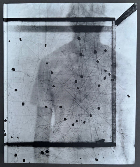 Book titled 'L'astropile ou le Reve Circulaire' by Laurent Millet with a grey cover featuring the image of a shadow of a man.