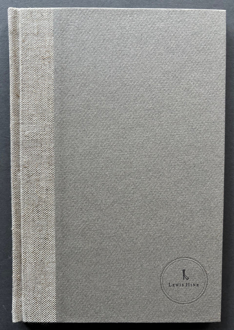 Book titled 'Ellis Island' by Lewis Hine with a grey cover.