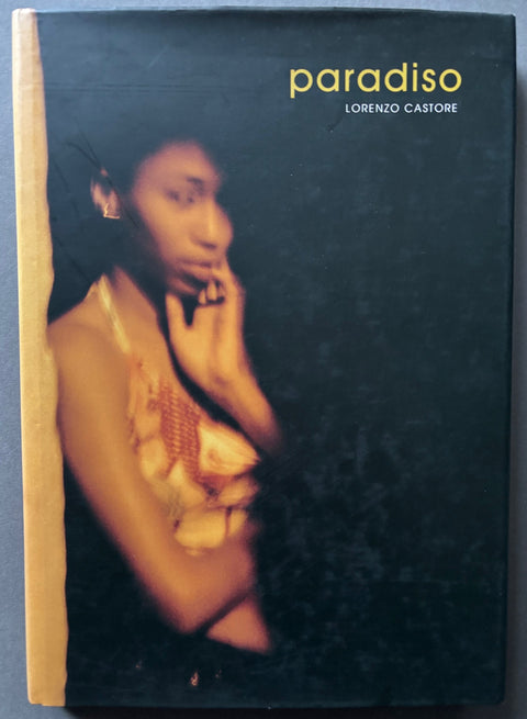 Book titled 'Paradiso' by Lorenzo Castore with a black cover featuring a woman standing in shadow. 