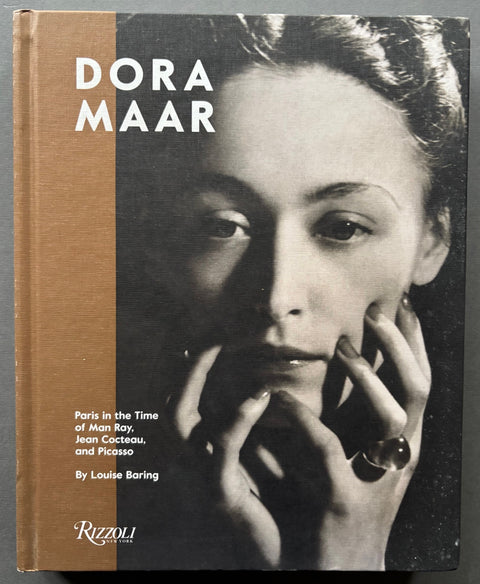 Book titled 'Dora Maar: Paris in the Time of Man Ray, Jean Cocteau and Picasso' by Louise Baring with a cover featuring the image of Nusch Eluard.