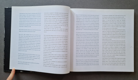 An open book Made in USA by Andre Kertesz showing two printed text pages with text both in English and French