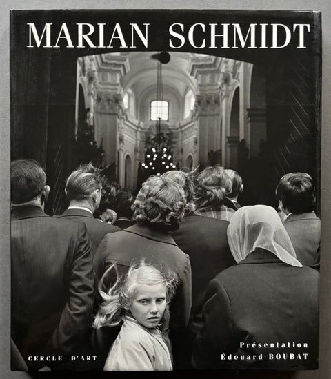 Book titled 'Marian Schmidt' with a black cover featuring the image of people walking into a building.