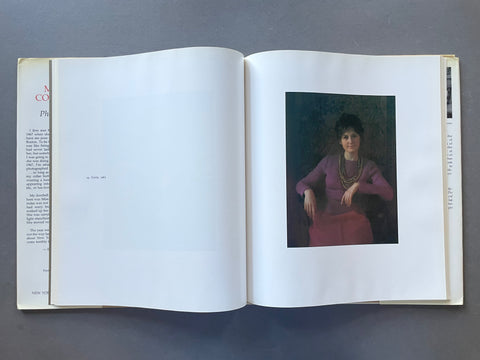 An open book laid flat on a dark gray surface, showing a printed portrait of a seated woman in a purple dress on the right page. The left page is mostly blank with faint text, and the book edges show the title 'Portraits' and the name 'Mina.