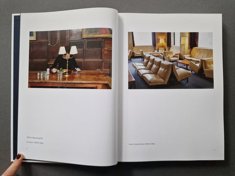 An open book; The left page shows a small interior photo of a man seated at a wooden desk, and the right page shows a larger photo of a leather lounge room.