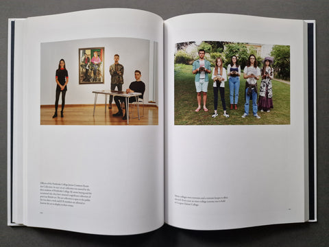 An open hardcover book spread showing two printed photographs on white pages, photographed against a dark gray background.