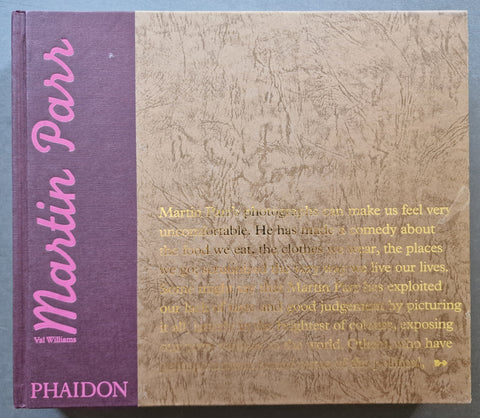 A hardcover book titled 'Martin Parr' by Val Williams, published by Phaidon. The cover features a textured light brown/tan background with gold text and a solid purple spine band with pink lettering.