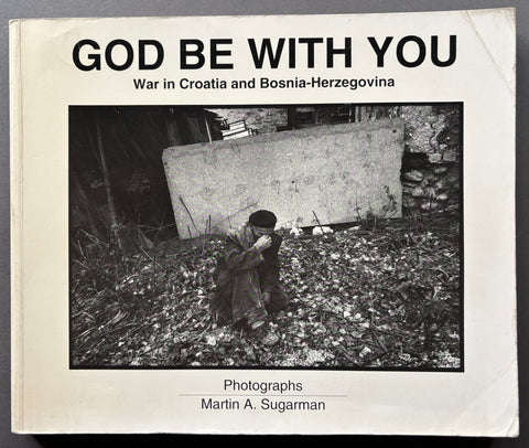 Book titled 'God be with You' by Martin A. Sugarman with a white cover featuring a black and white image of a man crouching with his fingers to the bridge of his nose.