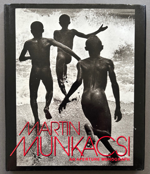 Book titled 'An Aperture Monograph' by Martin Munkacsi with a cover featuring the image of 3 naked boys running into the ocean.