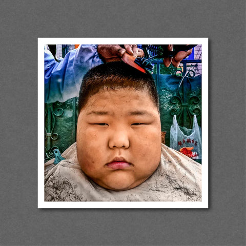 A Boy Gets A Haircut In The Street. Dalian, China