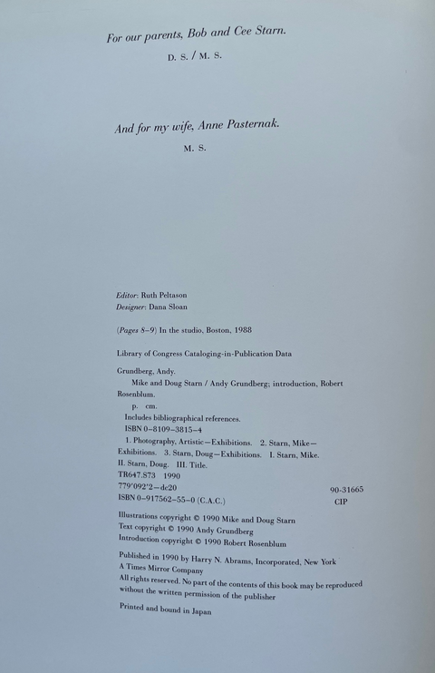 A printed book page with black text on a white page, photographed from above at a slight angle. The page includes family dedicatory text and publication credits.