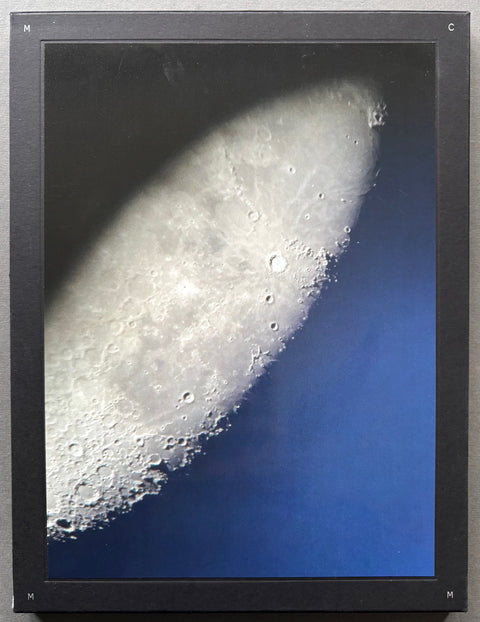 Book titled 'Moon City' by Mimi Mollica with a black cover featuring an image of the surface of the moon.