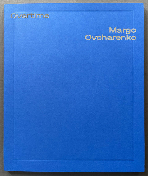 Blue book titled 'Overtime' by Margo Ovcharenko on a gray background