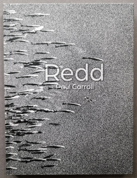 The cover of Redd by Paul Carroll in grainy gray showing an underwater photo of fish swimming.