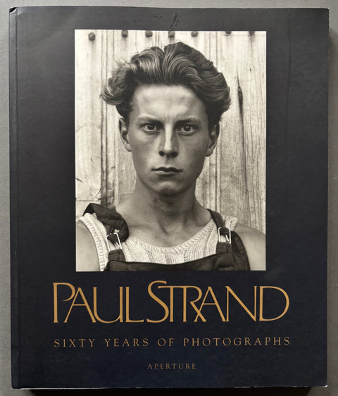 Book titled 'Sixty Years of Photography' by Paul Strand with a cover featuring a head shot of a young man.