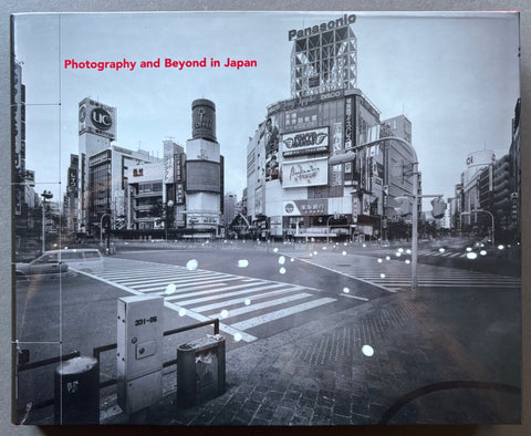 Book titled 'Photography and Beyond in Japan by various photographers with cover featuring a black and white image of a city road junction.