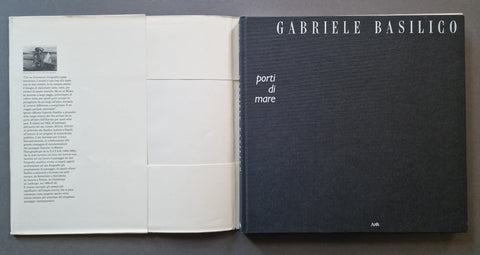 a black textured cover on the right page with the title 'GABRIELE BASILICO' and 'porti di mare'.