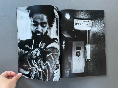 Image of a man holding a cat and door.