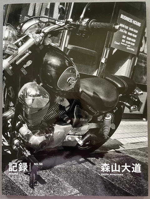 Black and white motorcycle photo with visible text on a gray background