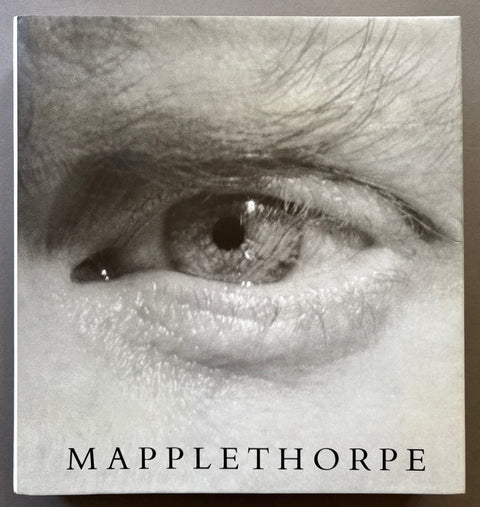 Book titled 'Mapplethorpe' by Robert Mapplethorpe with a cover featuring a black and white photograph of an eye.