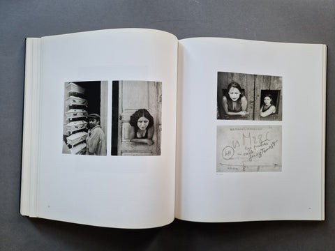 An open book, showing two white pages with several black-and-white portrait photographs and a handwritten note on the right page.