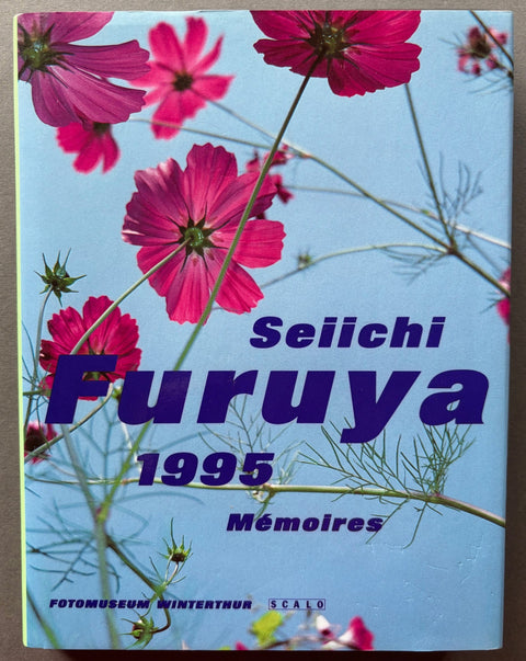 Book titled 'Memories 1995' by Seiichi Furuya with a cover featuring an image of pink flowers against a blue sky.