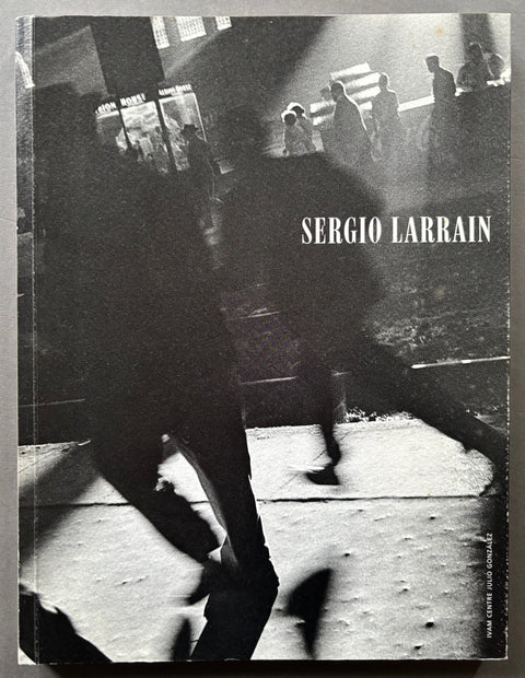 Book titled 'Sergio Larrain' by Rene Burri with a black and white cover of people on a train platform.