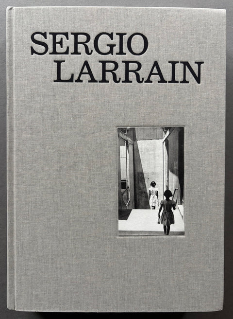 Book titled 'Sergio Larrain' by Sergio Larrain with a grey cover featuring the image of girls walking down steps.