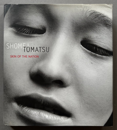 Book titled Skin of the Nation' by Shomei Tomatsu with a cover featuring a close up image of a face.