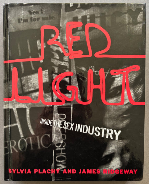 Book titled 'Red light: Inside the Sex Industry' by Sylvia Plachy and James Ridgeway with a black and white cover with red writing.