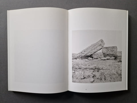 An open book, showing a black-and-white nature photograph printed on the right page with a large blank white page on the left.