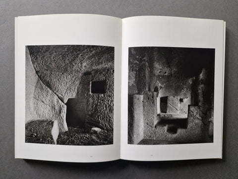 An open book, showing two black-and-white architectural photographs printed on the pages.