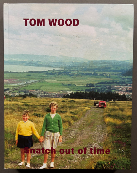 Book titled 'Snatch Out Of Time' by Tom Wood with a cover featuring a photograph of 2 children holding hands out on a British hillside.