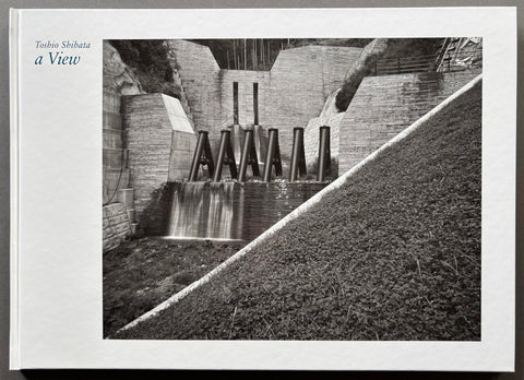 Booked titled a View by Toshio Shibata with a white cover including a photograph of a dam.