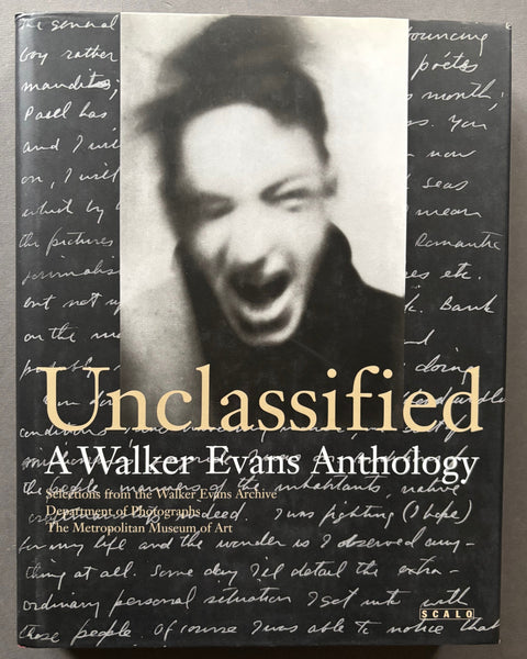 Book titled 'Unclassified: A Walker Evans Anthology' with a black cover featuring the image of a mans head with open mouth a=surrounded by script writing.