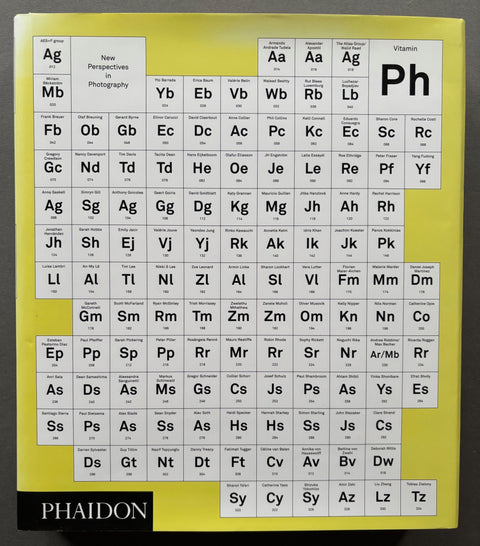 Book titled 'Vitamin Ph: New Perspectives in Photography' published by Phaidon with a yellow cover featuring an image of the periodic table.