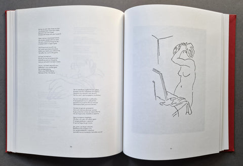 An open book laid flat on a dark gray surface, showing printed text and line drawings on white pages.