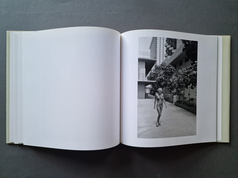 An open book, showing a black-and-white architectural photograph printed on the right page and blank white pages on the left.