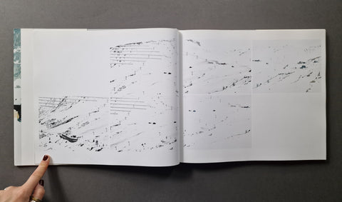 An open book, showing 6 snowy landscape photographs