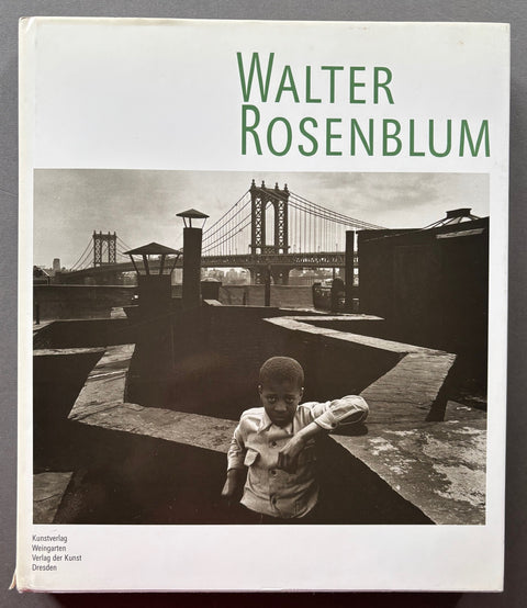 Book titled 'Walter Rosenblum: Photographer' with a white cover featuring a photograph of a young boy standing on a rooftop with the Brooklyn Bridge in the back ground.