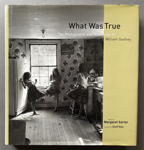 Book titled 'What Was True: The Photographs and Notebooks of William Gedney' with a beige cover featuring the image of 3 girls in a kitchen.
