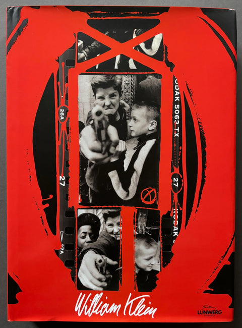 Book titled 'Retrospective' by William Klein with a red and black cover featuring photographs of a boy with a gun.