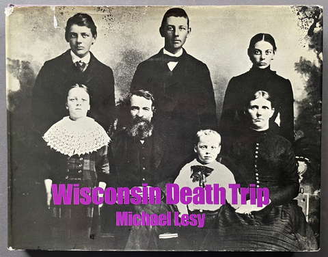 Front cover of Wisconsin Death Trip by Michael Lesy with a black and white family portrait. 