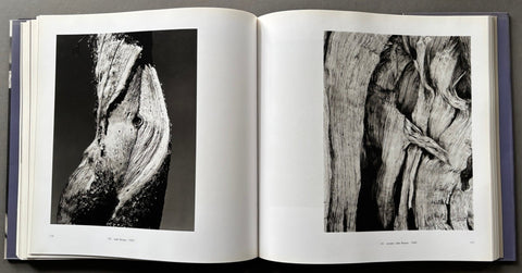Open book showing black and white photographs of wooden textures