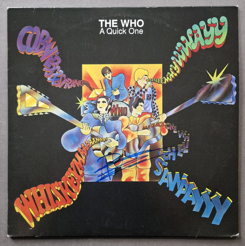 The Who - A Quick One vinyl record album cover, signed in blue ink across the center, photographed flat against a neutral gray background.