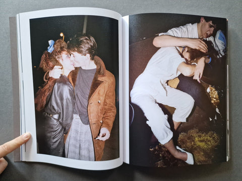 An open book, showing two printed photographs spread across the pages. 