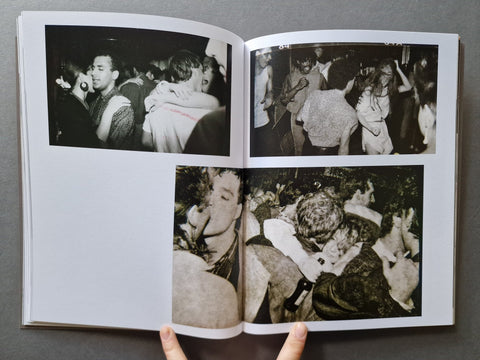 An open book, showing four black-and-white photographs printed on the pages. 