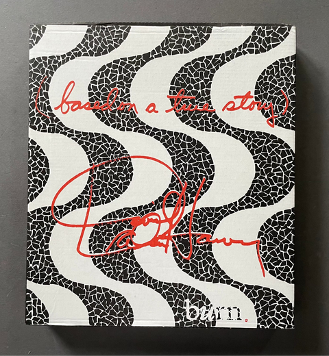 Book cover with black and white pattern and red text on a dark gray background