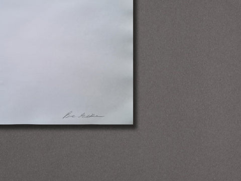 A minimalist art print or poster featuring a white square with a faint signature in the lower-left corner, set against a textured dark gray background.
