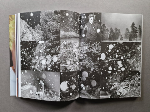 An open book, showing a black-and-white collage of snowy forest scenes and a person in one of the panels.